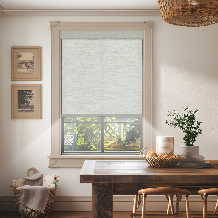 Custom light filtering linen roller shades in neutral linen look, installed in cozy dining area with garden view