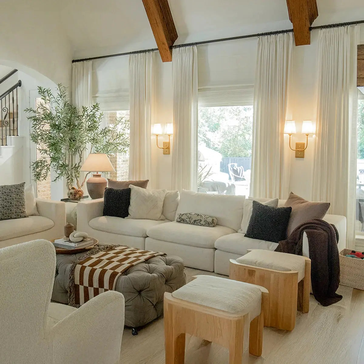 Drapery framing a softly furnished room