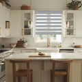 Light gray zebra shade over white kitchen window, cordless design