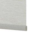 Rolled custom linen roller shade showing beige textured fabric and clean bottom bar detail