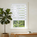 White zebra blinds in modern living room window, easy no-drill install