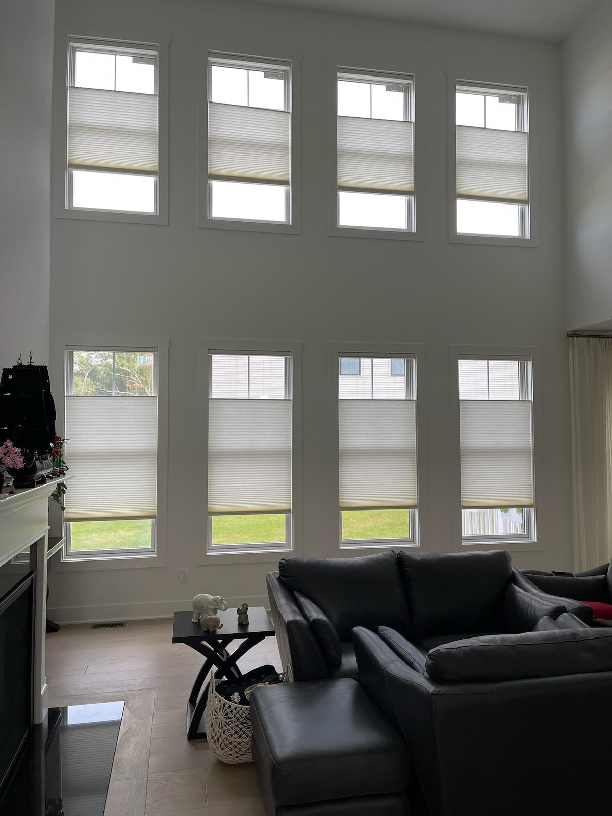KALIA cellular shades on two levels of windows in a living room